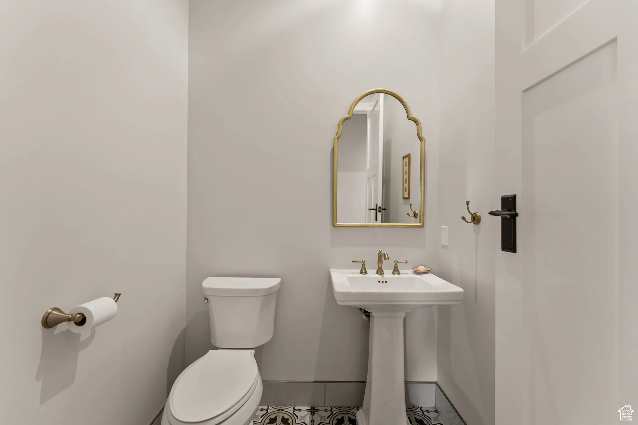 Bathroom with toilet and tile patterned flooring