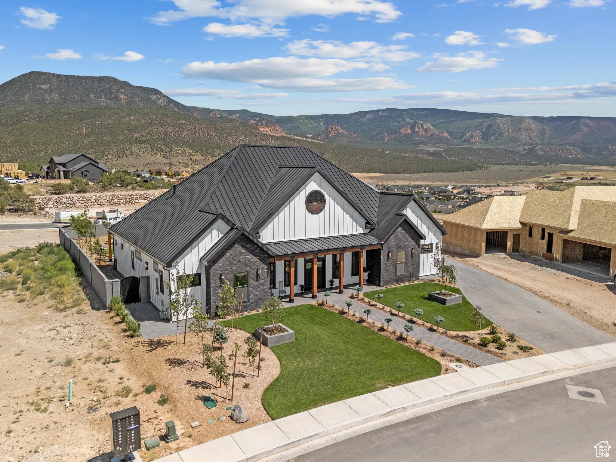 Modern farmhouse with a standing seam roof, board and batten siding, a mountain view, and a metal roof