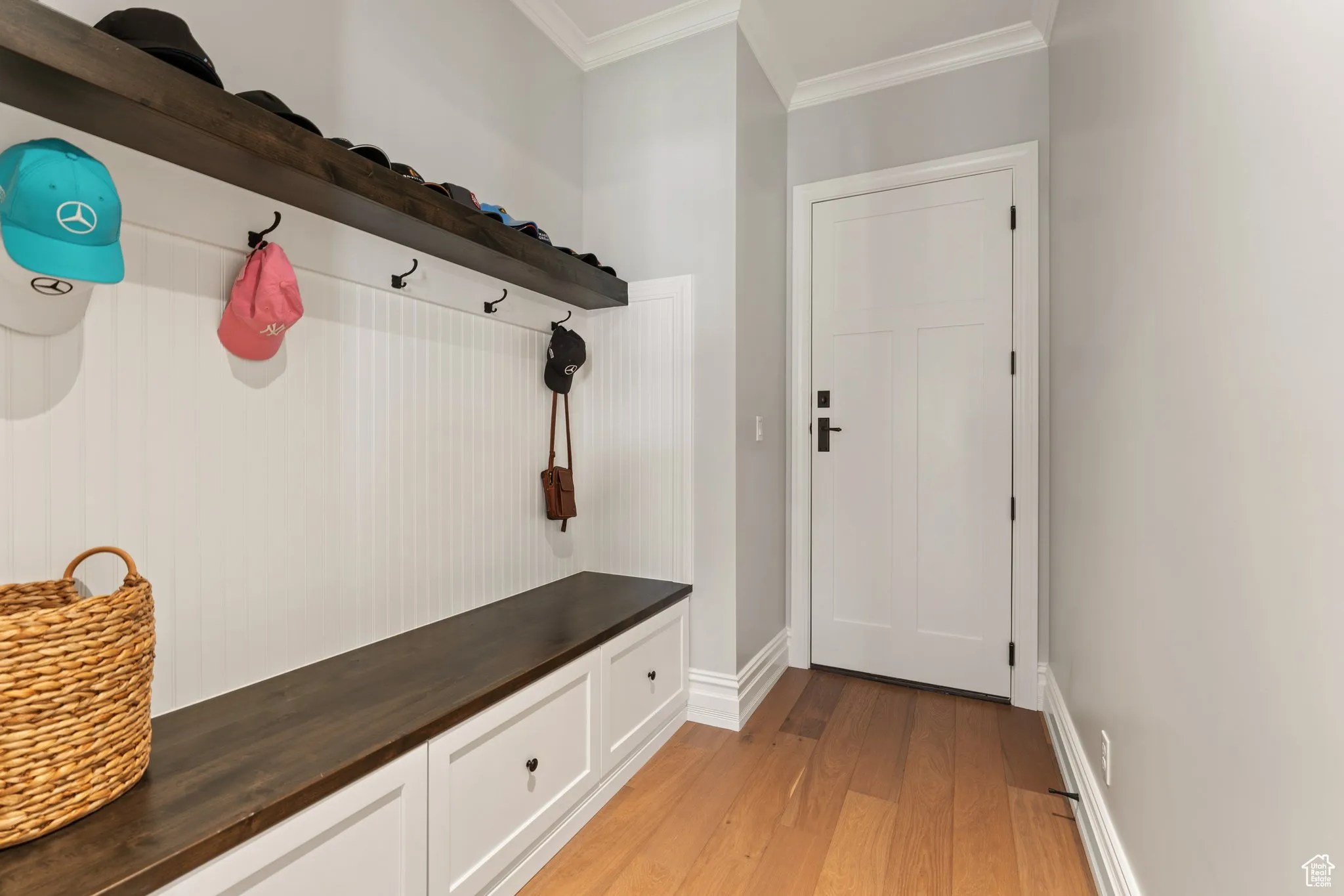Mudroom featuring ornamental molding and light wood finished floors