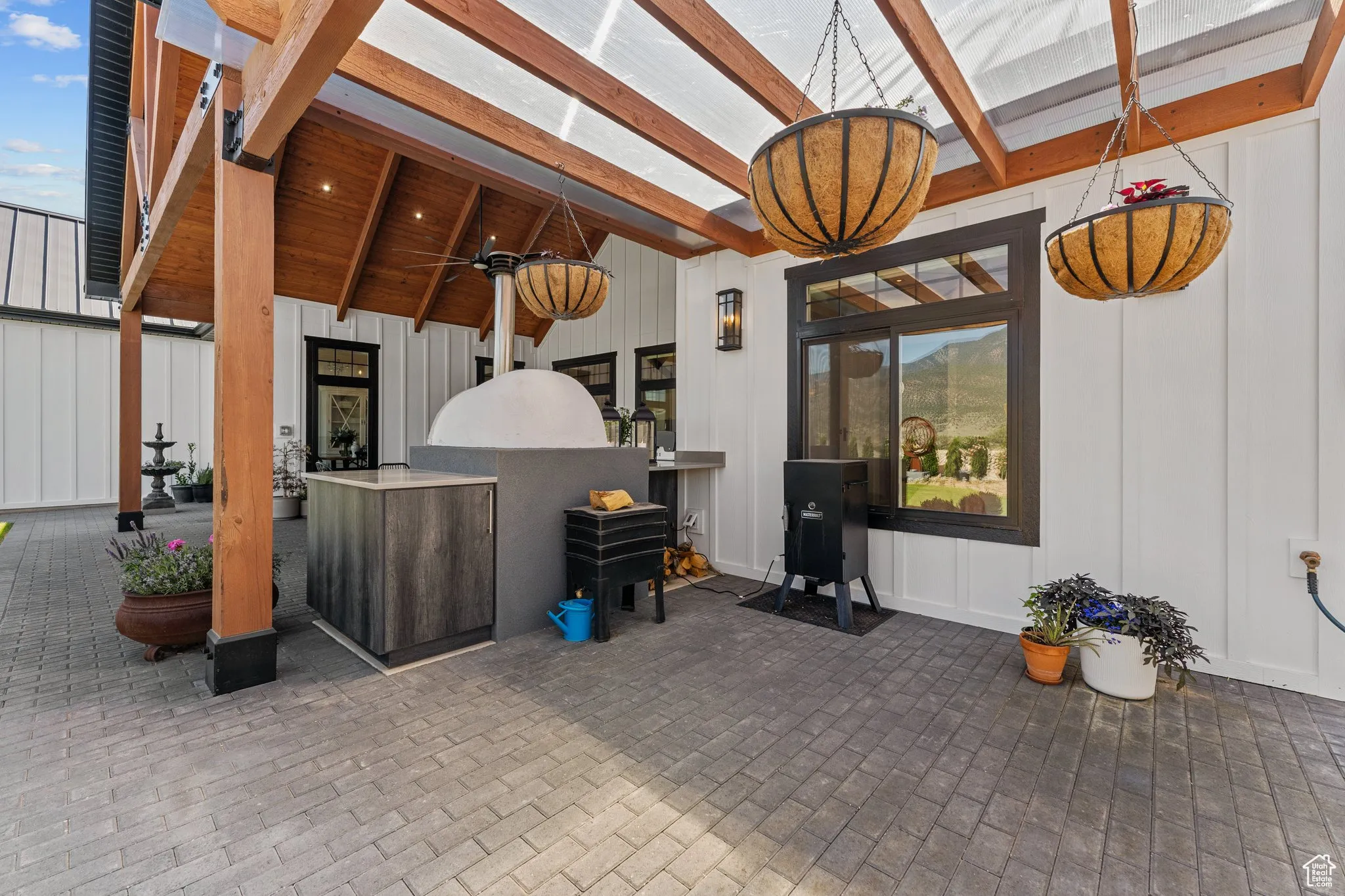 View of patio featuring a ceiling fan and exterior kitchen