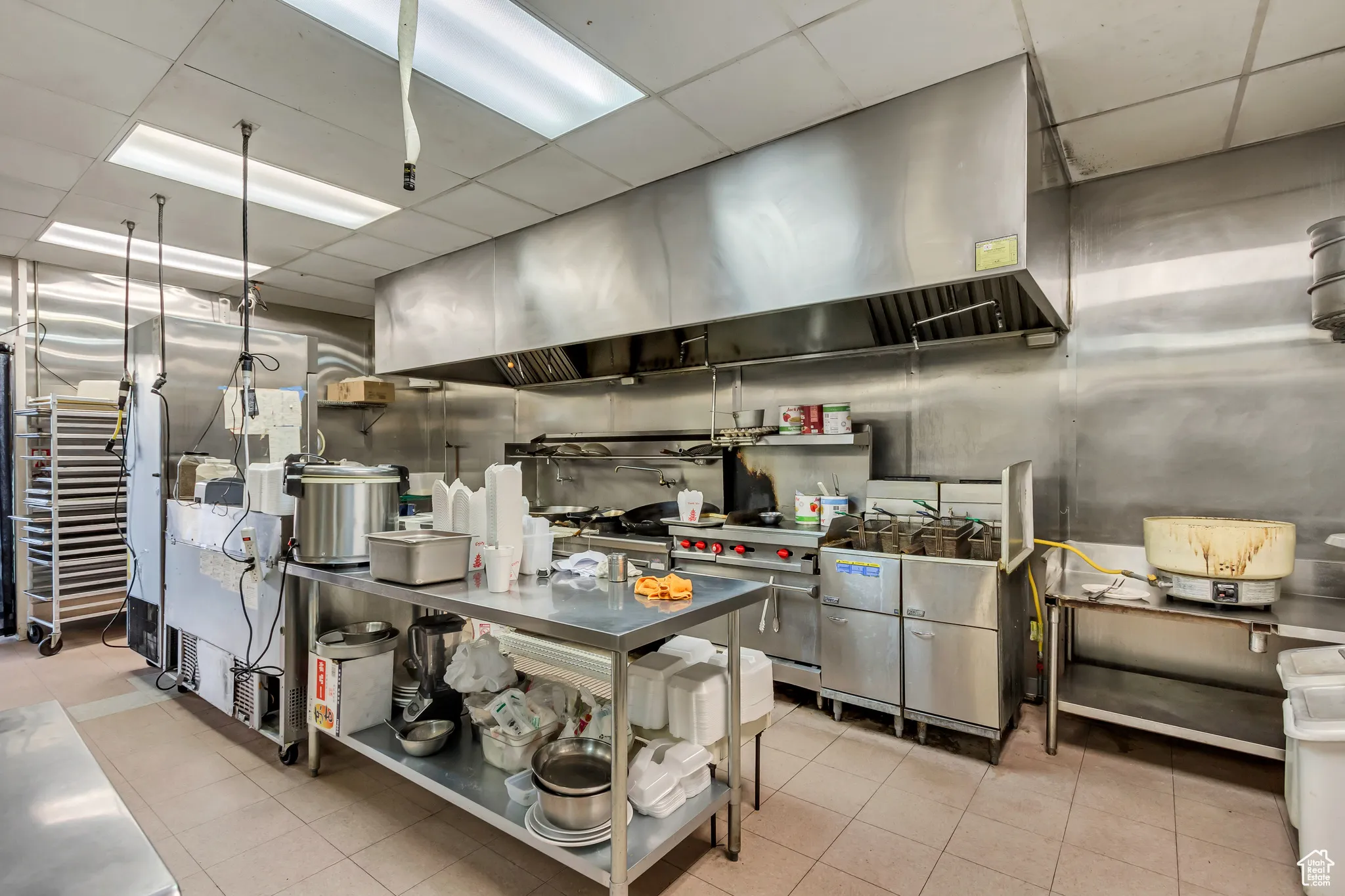 Kitchen with a drop ceiling and light tile patterned floors