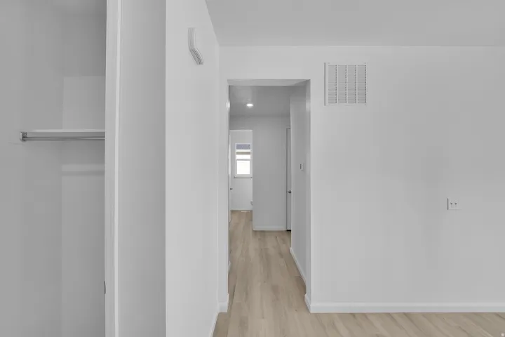 Hall featuring light wood-style floors and recessed lighting
