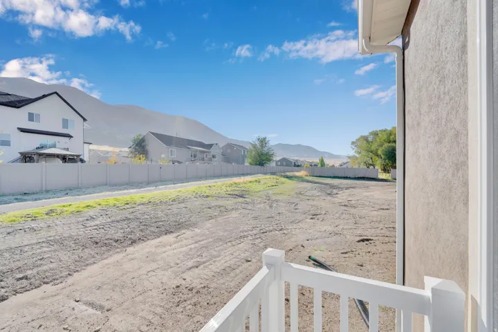 View of yard with a mountain view and a balcony