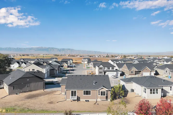 Aerial view of residential area featuring a mountainous background