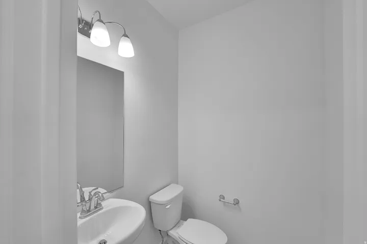 Half bathroom featuring a sink and toilet