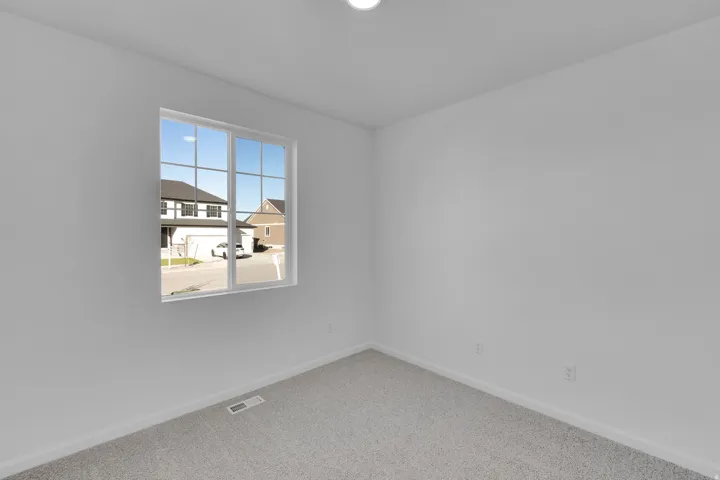 Unfurnished room with baseboards and carpet