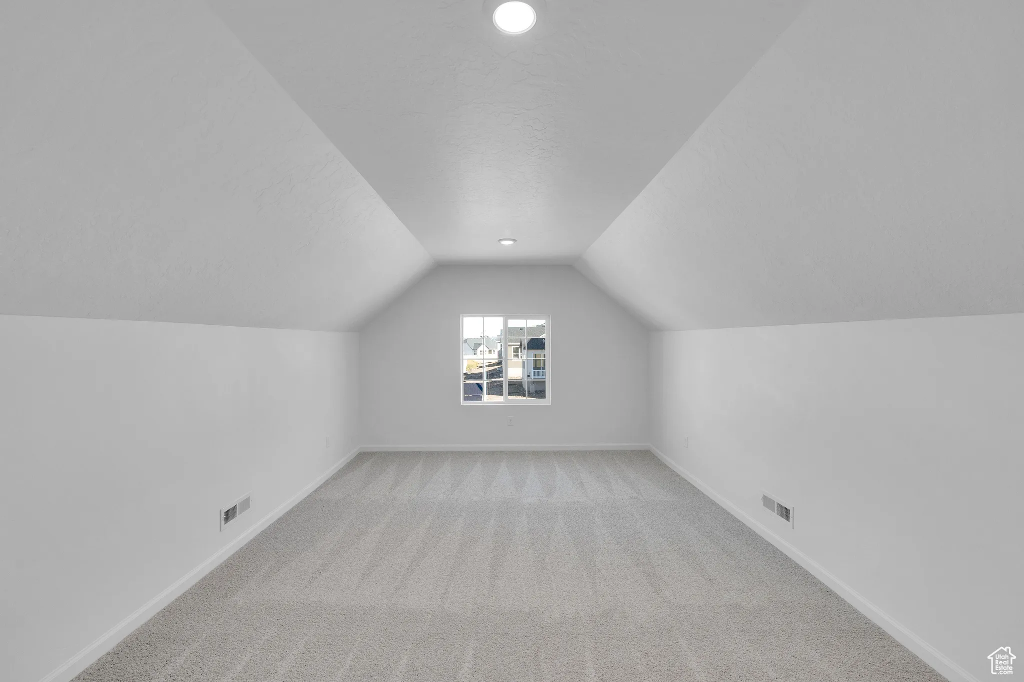 Bonus room featuring light colored carpet, lofted ceiling, a textured ceiling, and recessed lighting