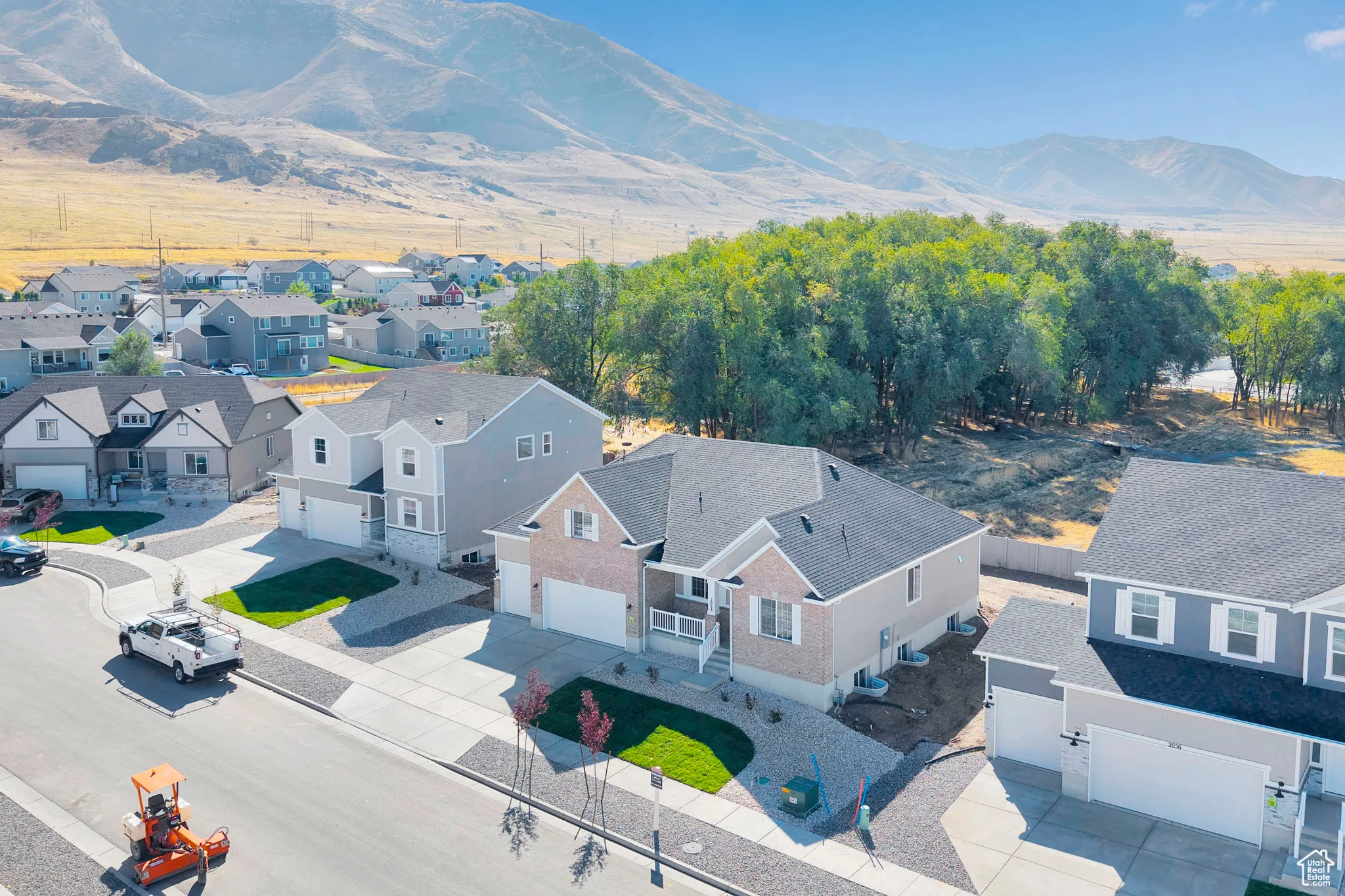 Aerial perspective of suburban area with a mountainous background