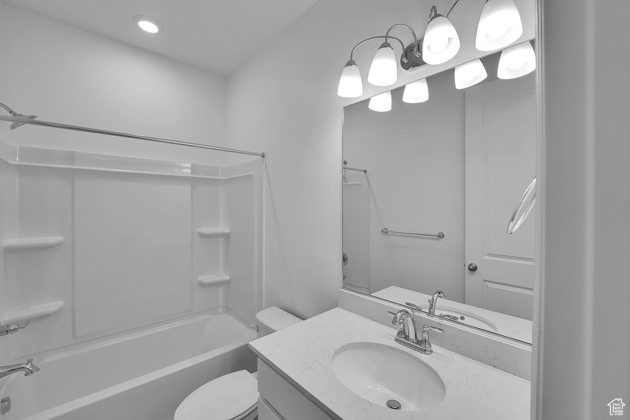 Bathroom with vanity, bathing tub / shower combination, and recessed lighting