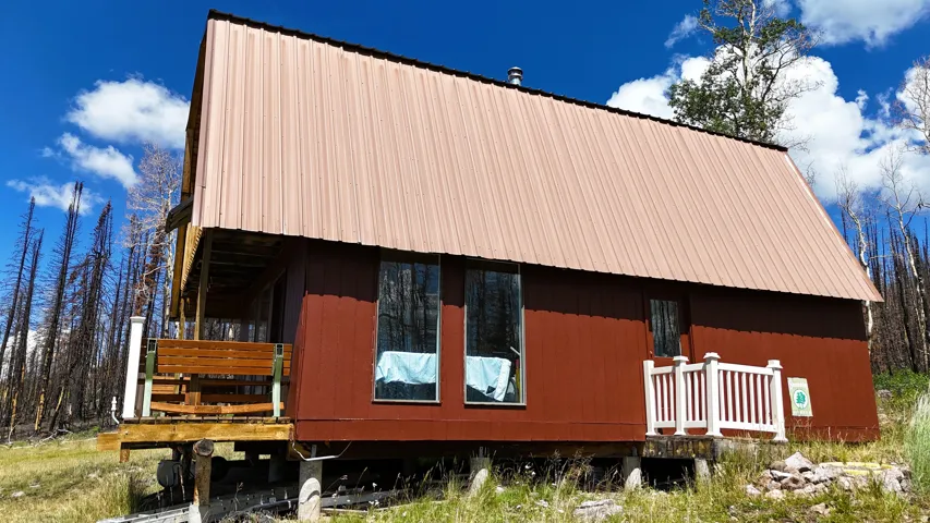 A-frame style structure featuring a brown metal roof and rich brown siding
