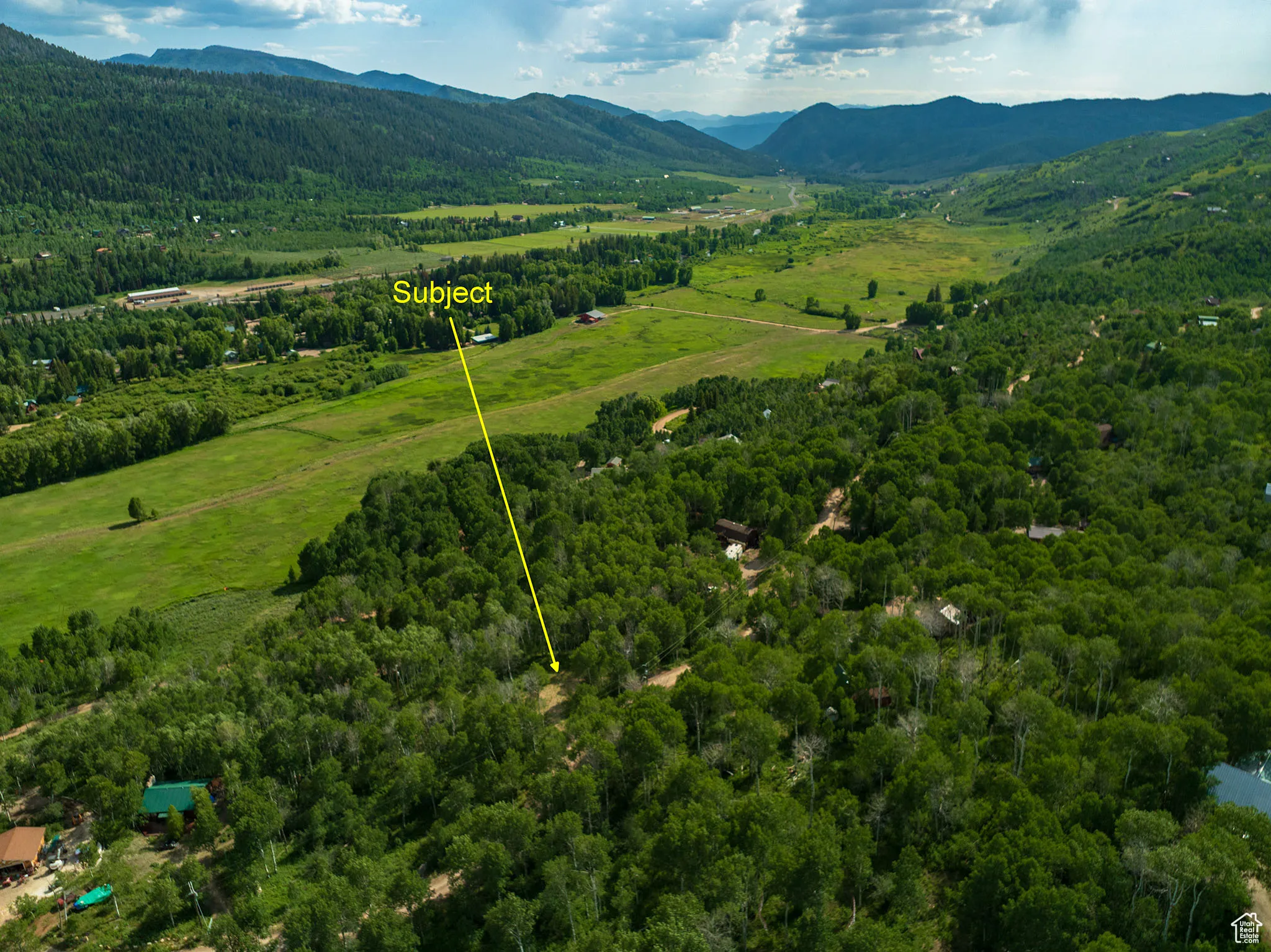 Aerial view of property's location with a mountain backdrop and property parcel outlined