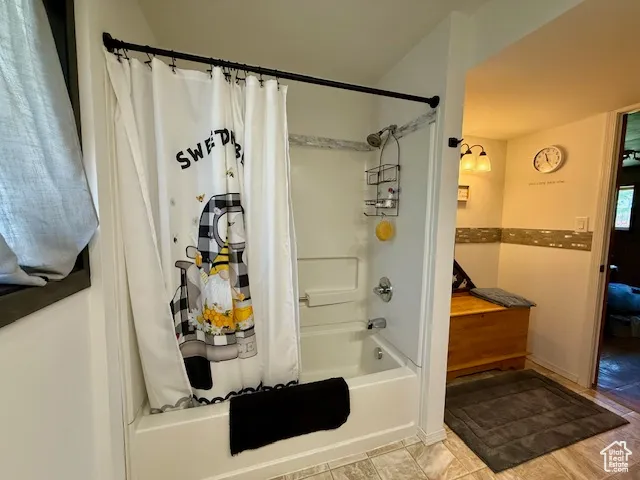 Bathroom with shower / bath combo with shower curtain