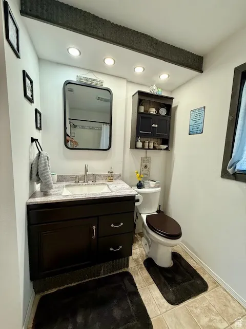 Bathroom with vanity, tile patterned flooring, and recessed lighting