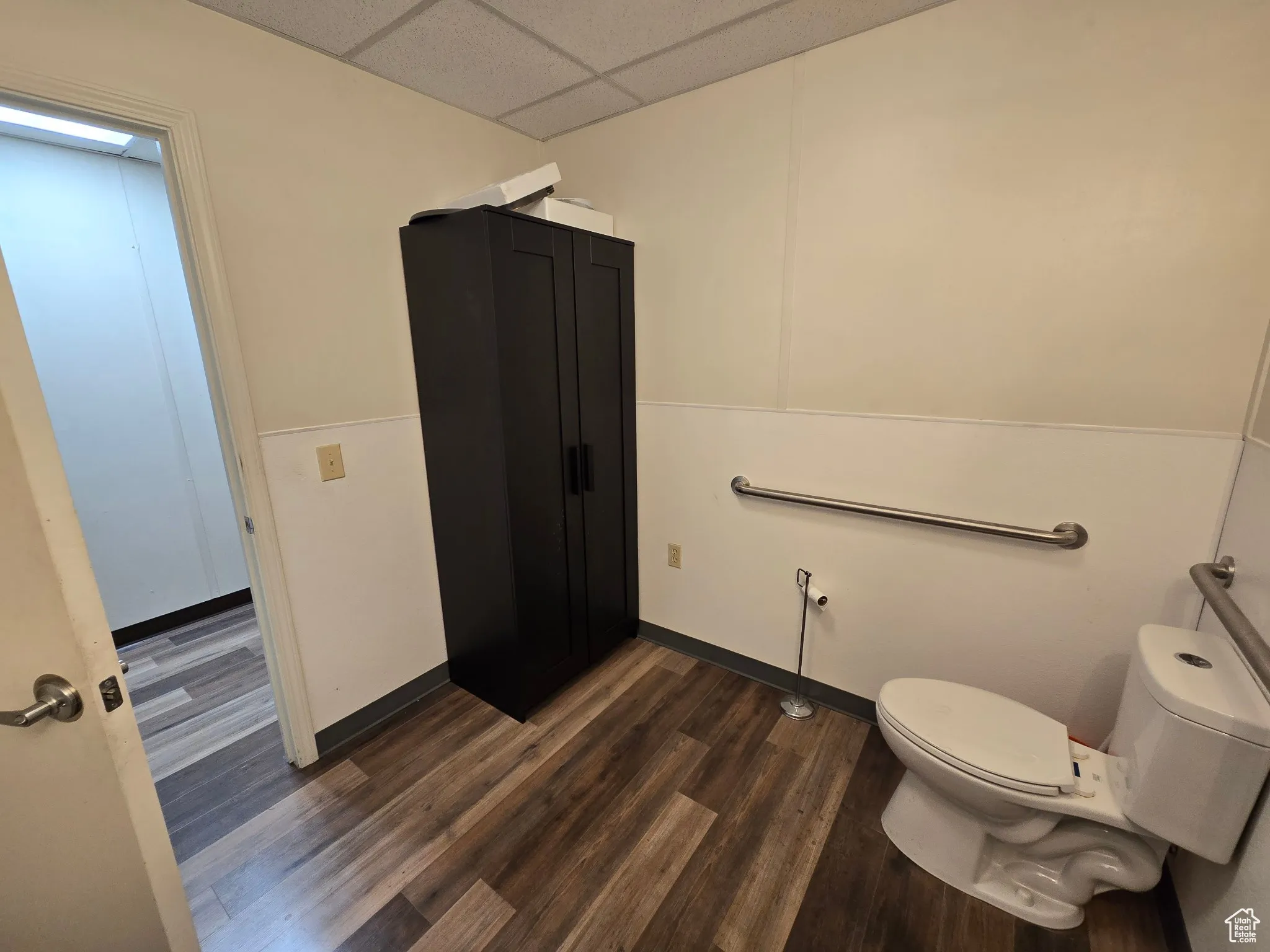 Bathroom with wood finished floors and a paneled ceiling
