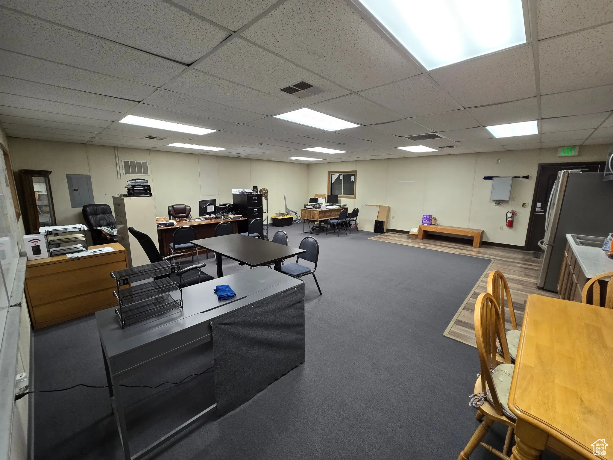 Office featuring a paneled ceiling and electric panel