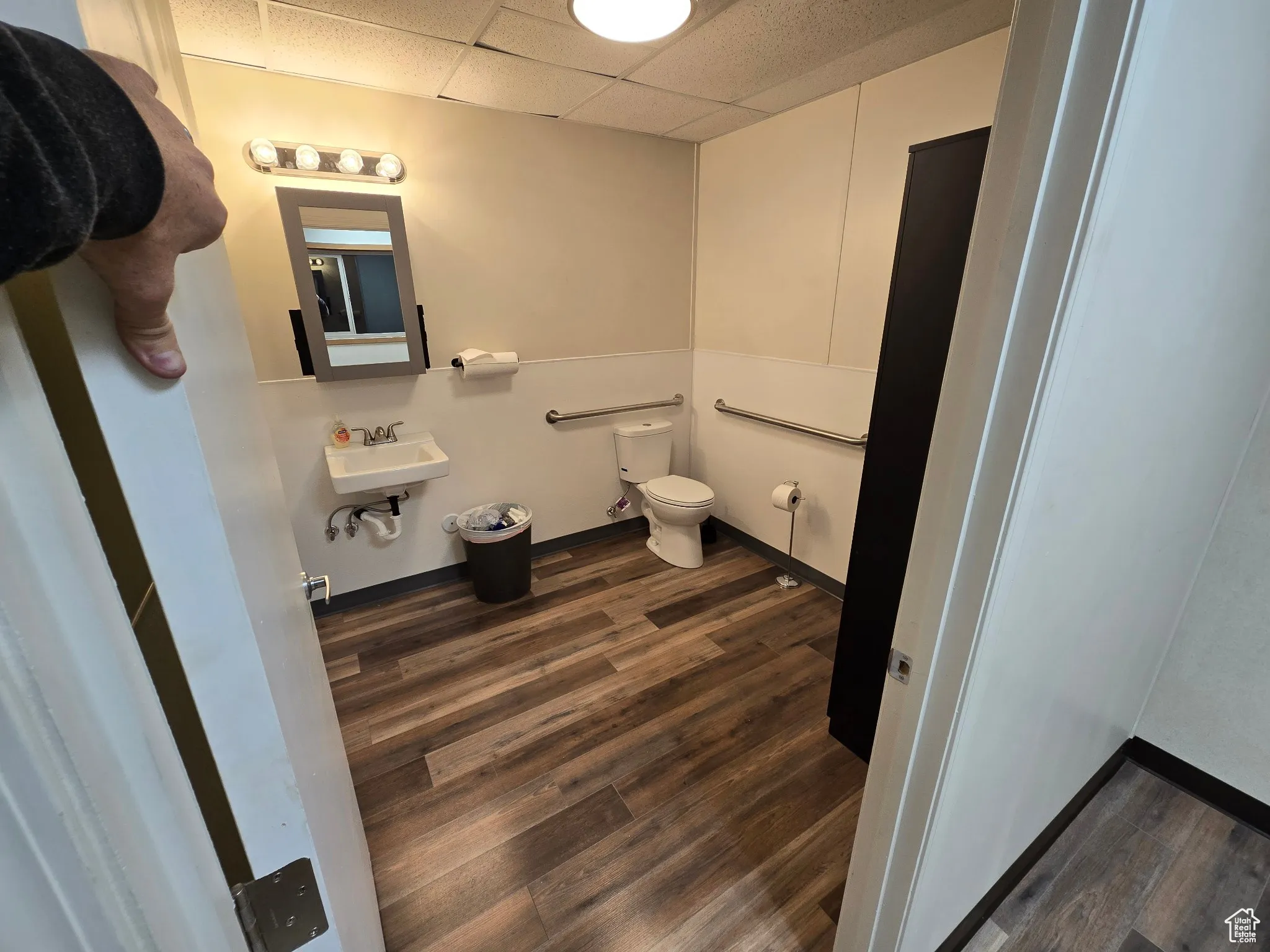 Bathroom with wood finished floors and a paneled ceiling
