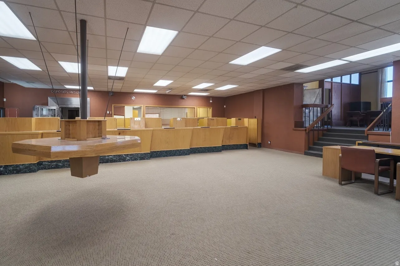 Miscellaneous room featuring a drop ceiling and stairway