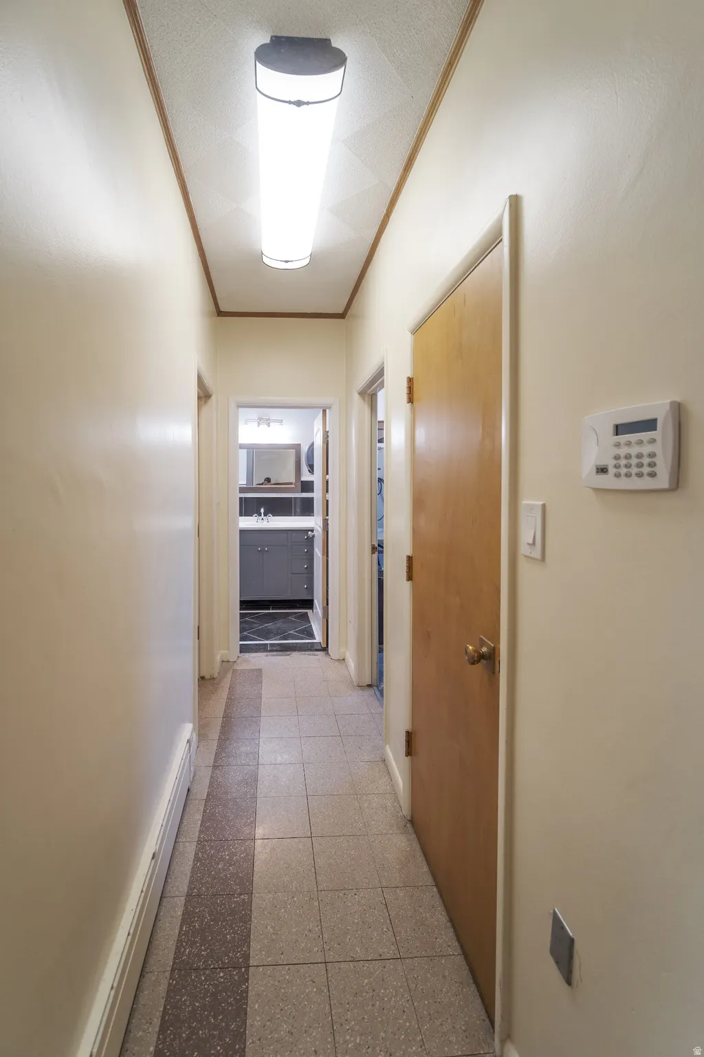 Hall featuring ornamental molding and a baseboard radiator