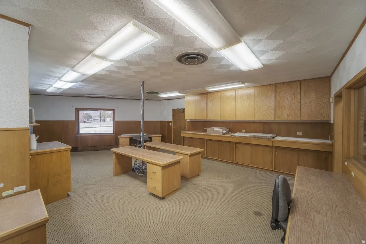 Office space with wood walls and wainscoting