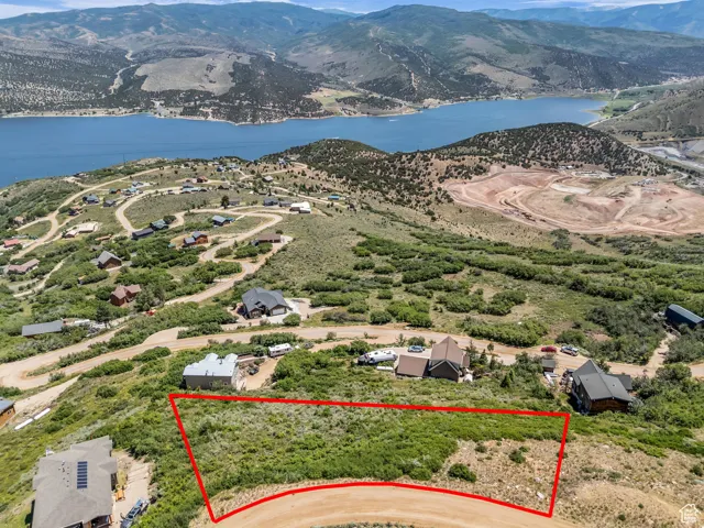 Aerial overview of property's location with a water and mountain view and property boundaries highlighted