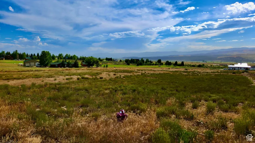 View of undeveloped land featuring a mountainous background and rural landscape