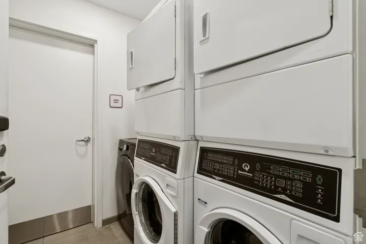 Washroom featuring washing machine and clothes dryer and light tile patterned floors