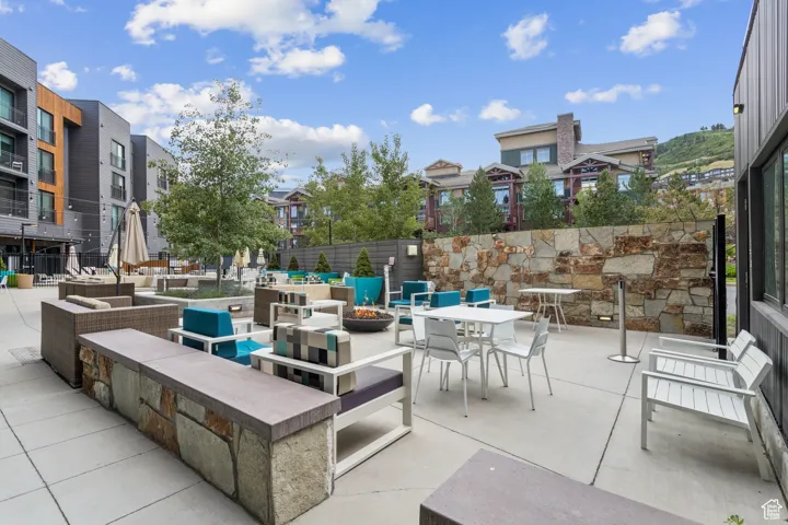 View of patio featuring a residential view and an outdoor living space with a fire pit