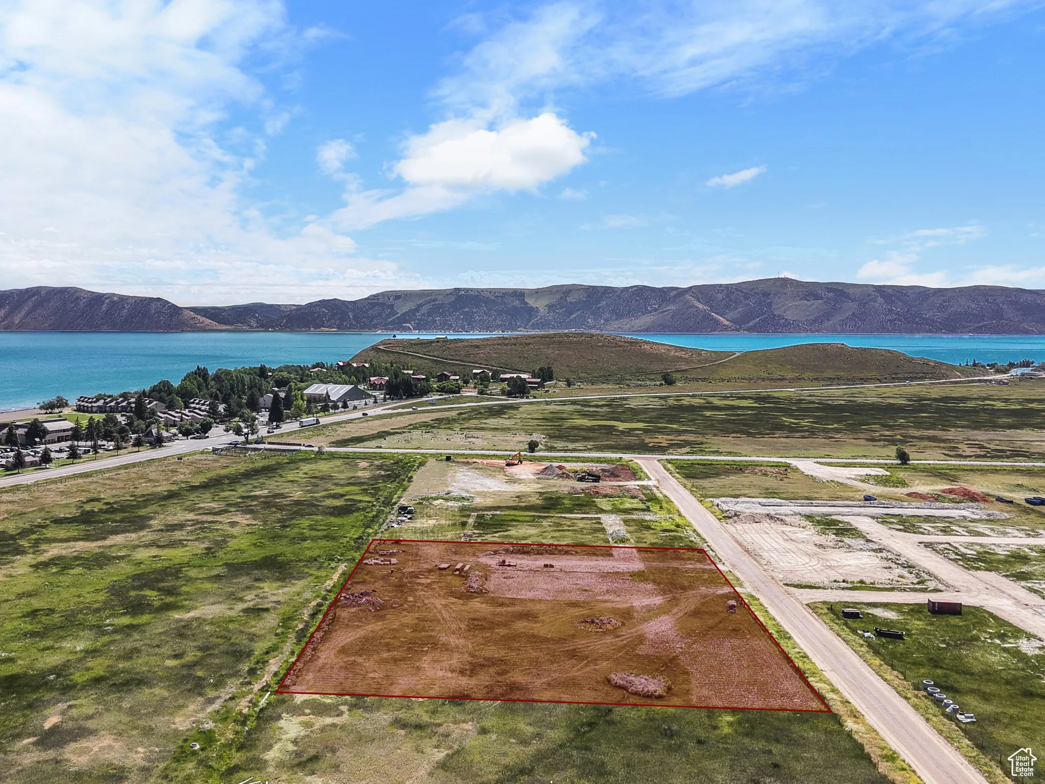 Aerial overview of property's location with a water and mountain view and property boundaries highlighted