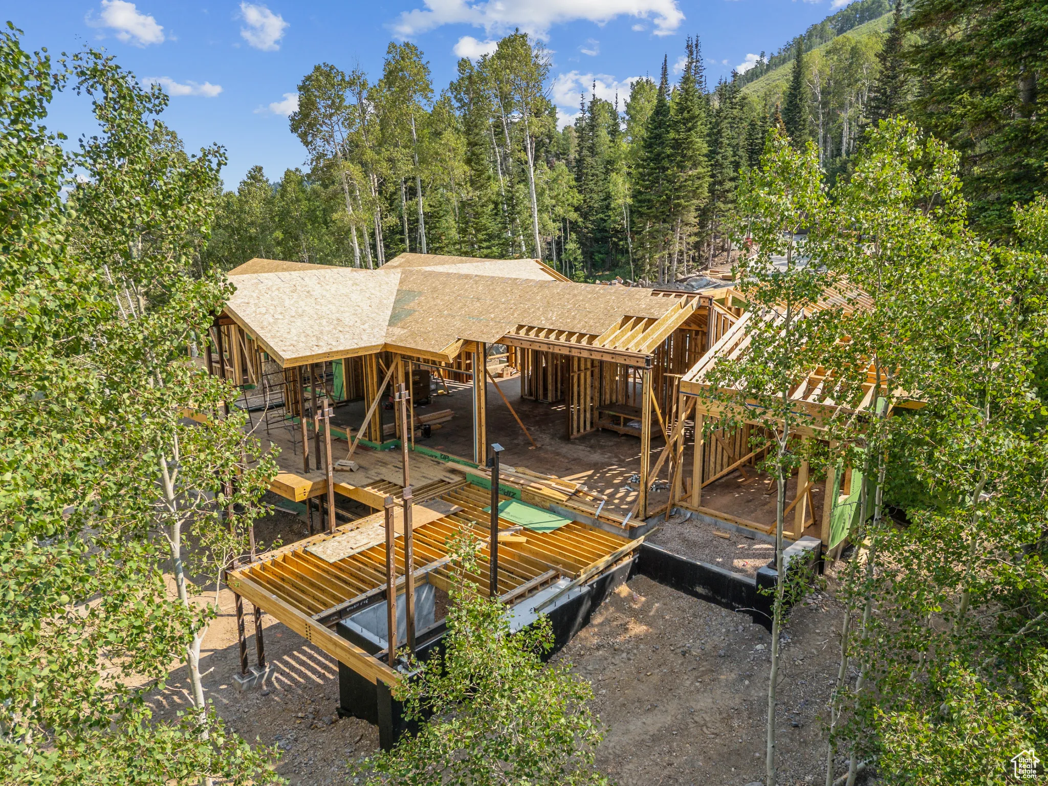 Back of house with a shingled roof and a wooden deck