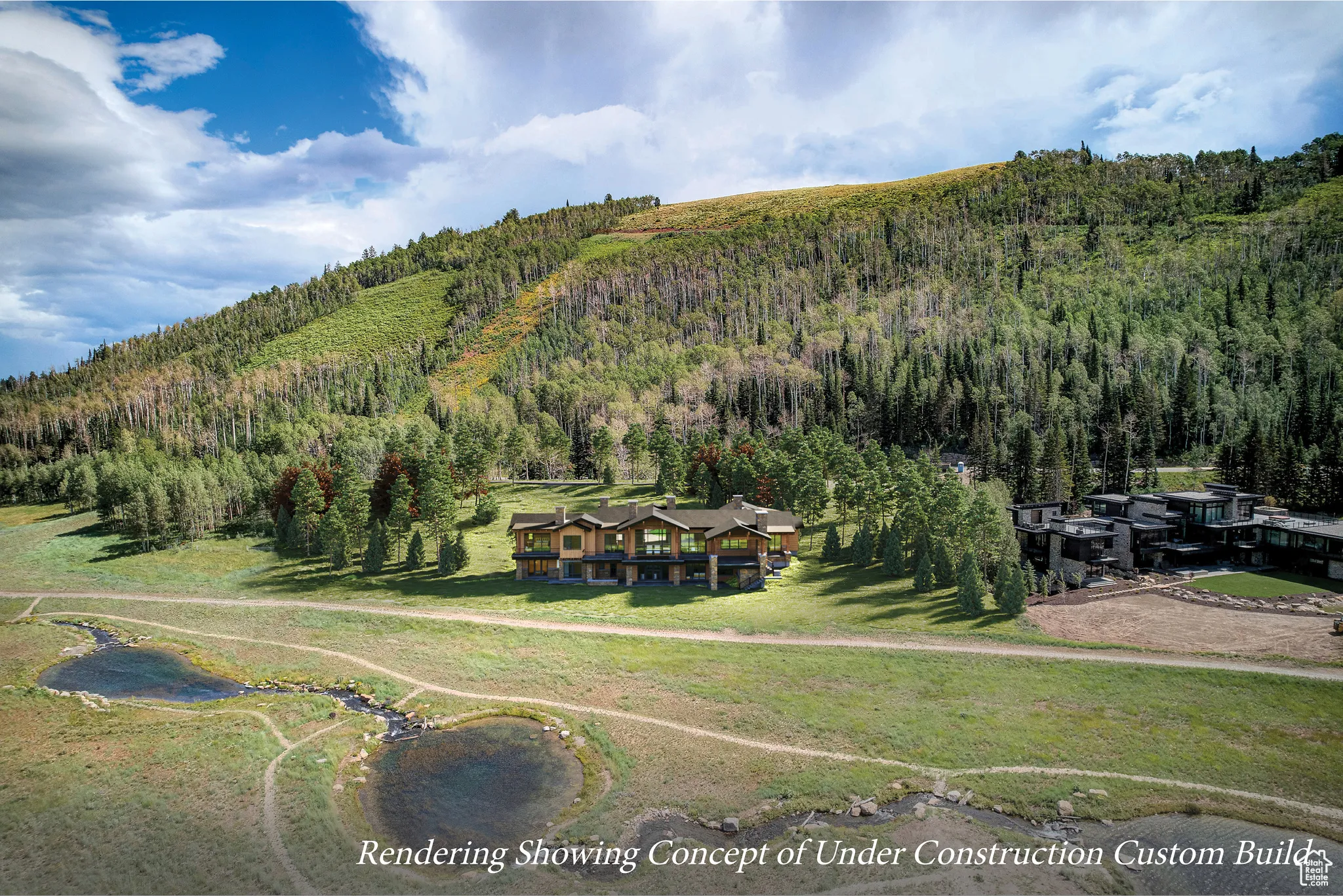Aerial view of property and surrounding area featuring a forest