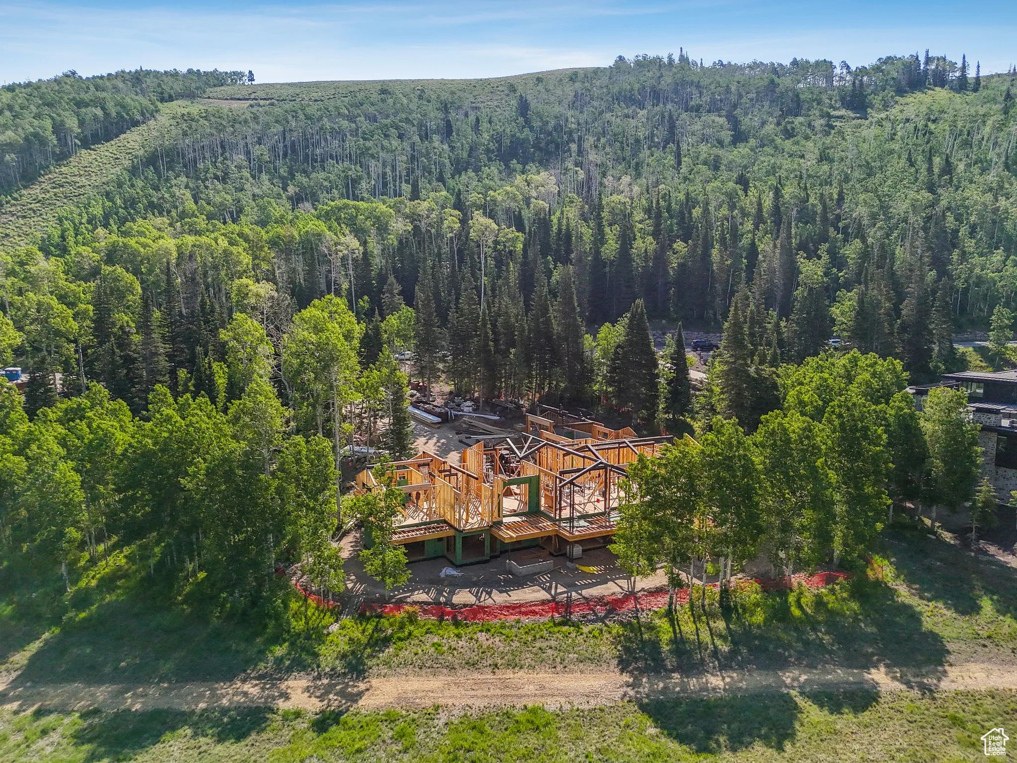 Aerial view of property and surrounding area featuring a heavily wooded area