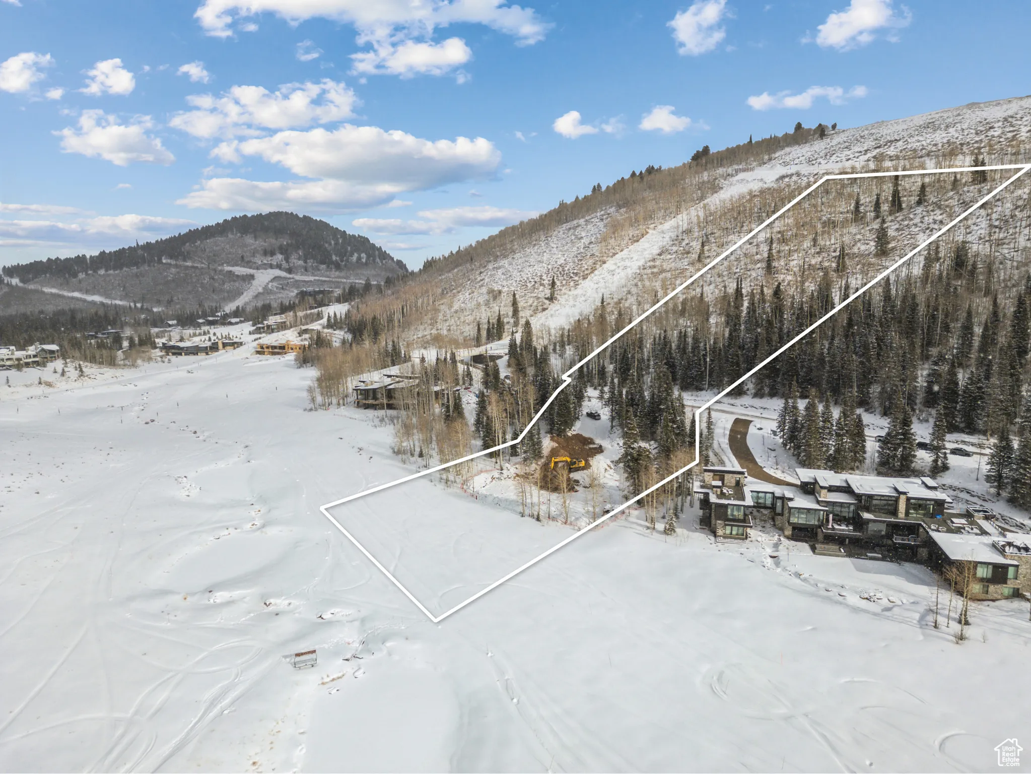 Snowy aerial view featuring a mountain view and property boundaries highlighted