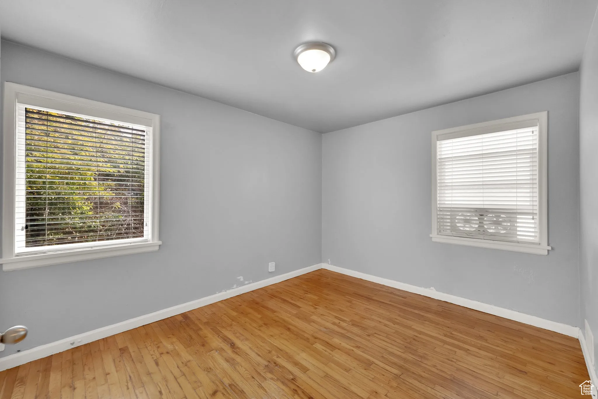 Spare room featuring baseboards and hardwood / wood-style flooring