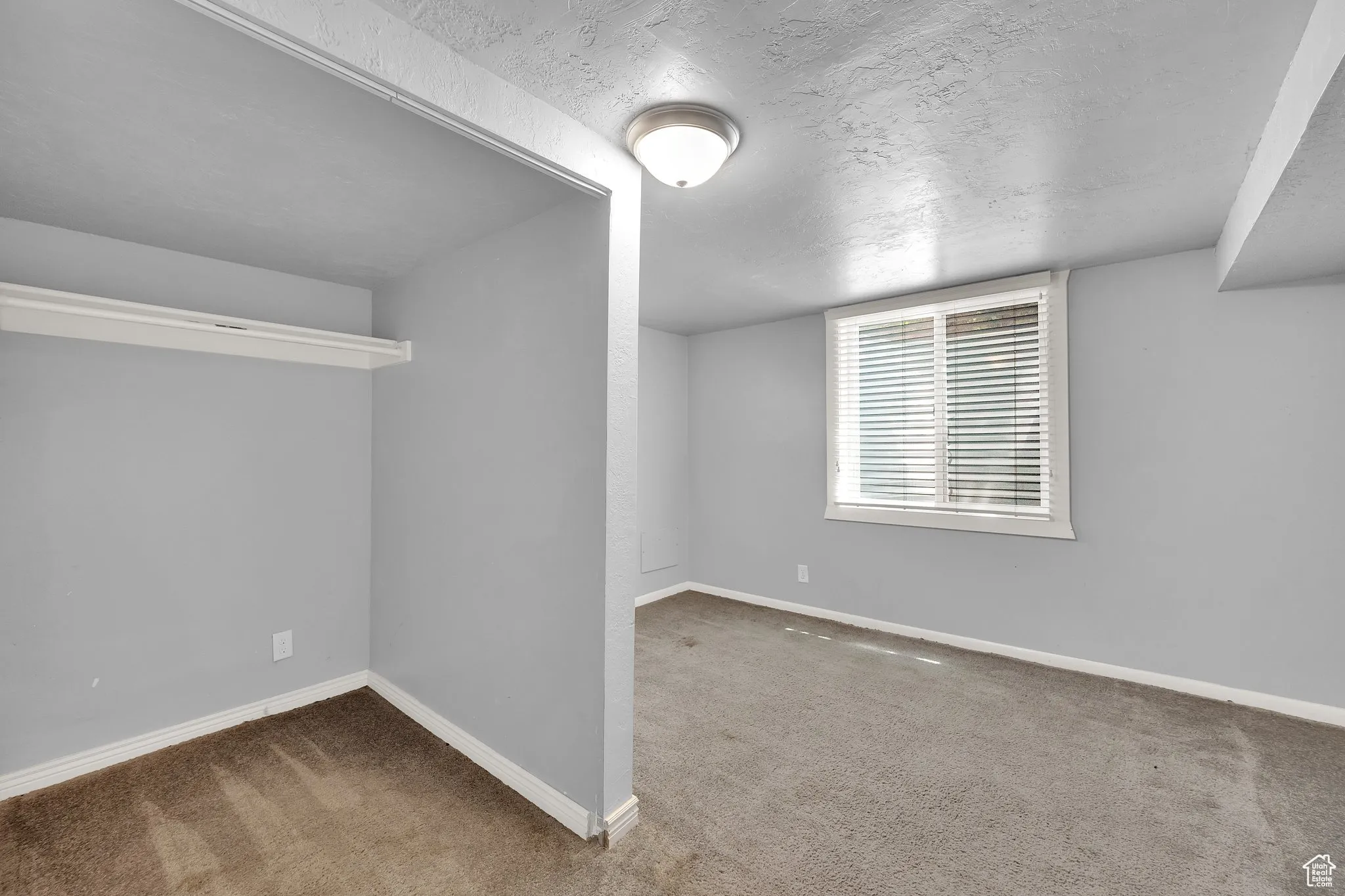 Spare room with carpet flooring and a textured ceiling