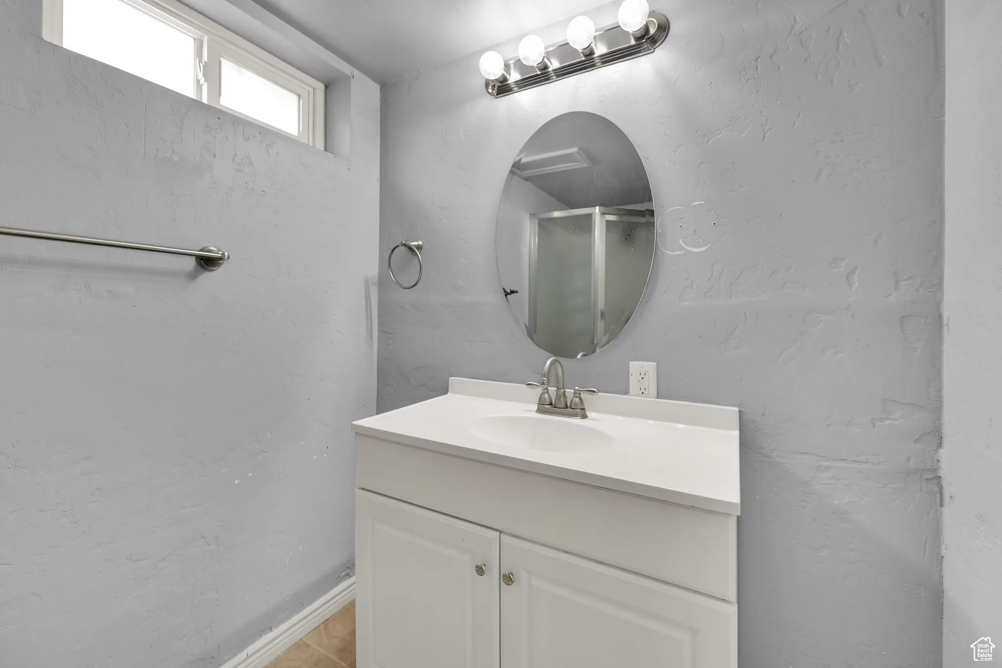 Bathroom with vanity and a shower