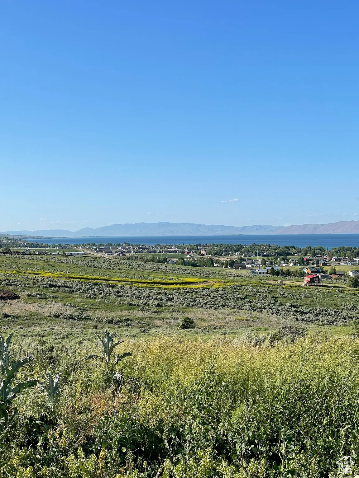 View of undeveloped land featuring mountains and lake