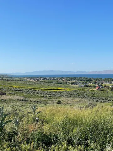 View of undeveloped land featuring mountains and lake