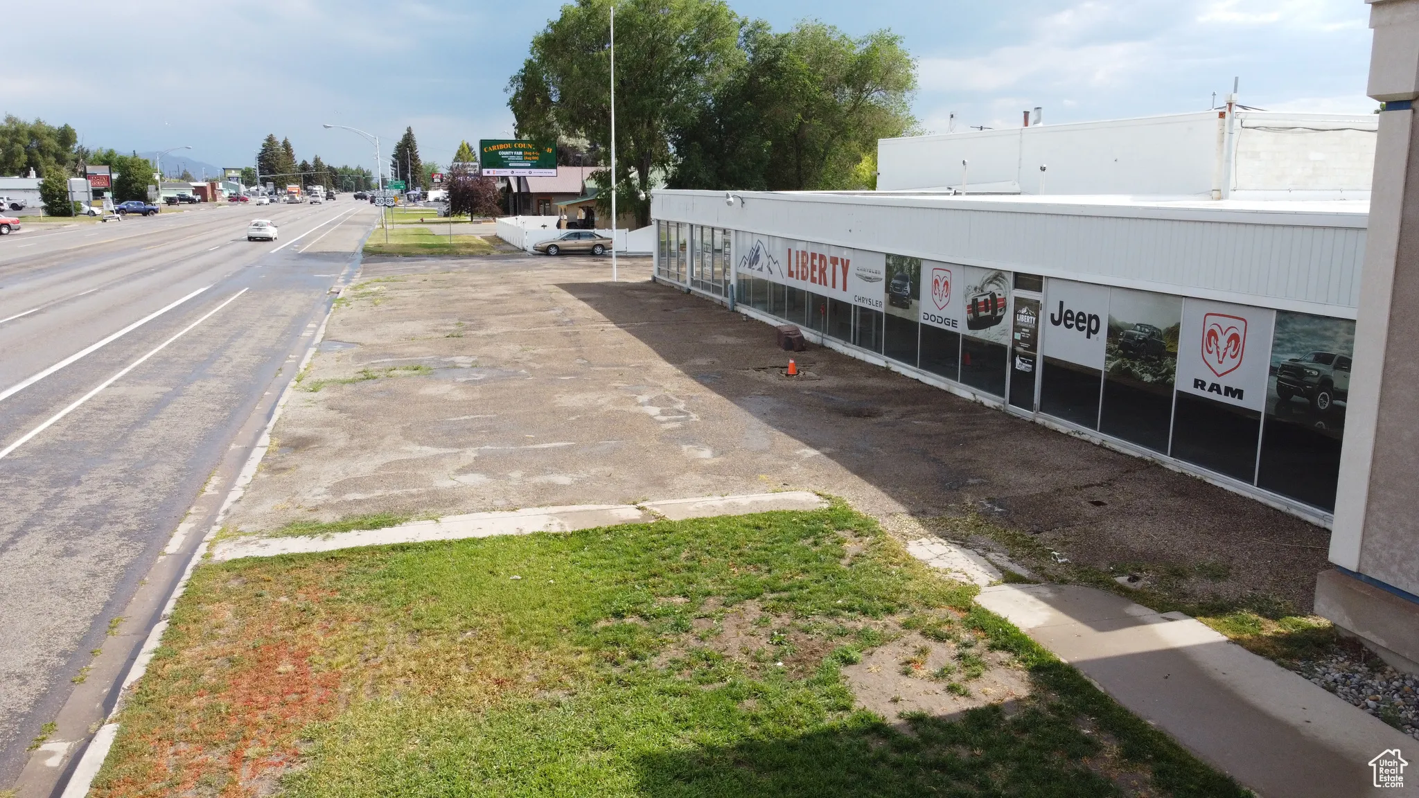 View of asphalt street with street lighting, curbs, and sidewalks