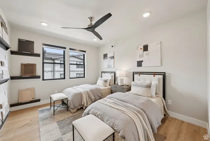 Bedroom featuring light wood-style flooring, ceiling fan, and recessed lighting