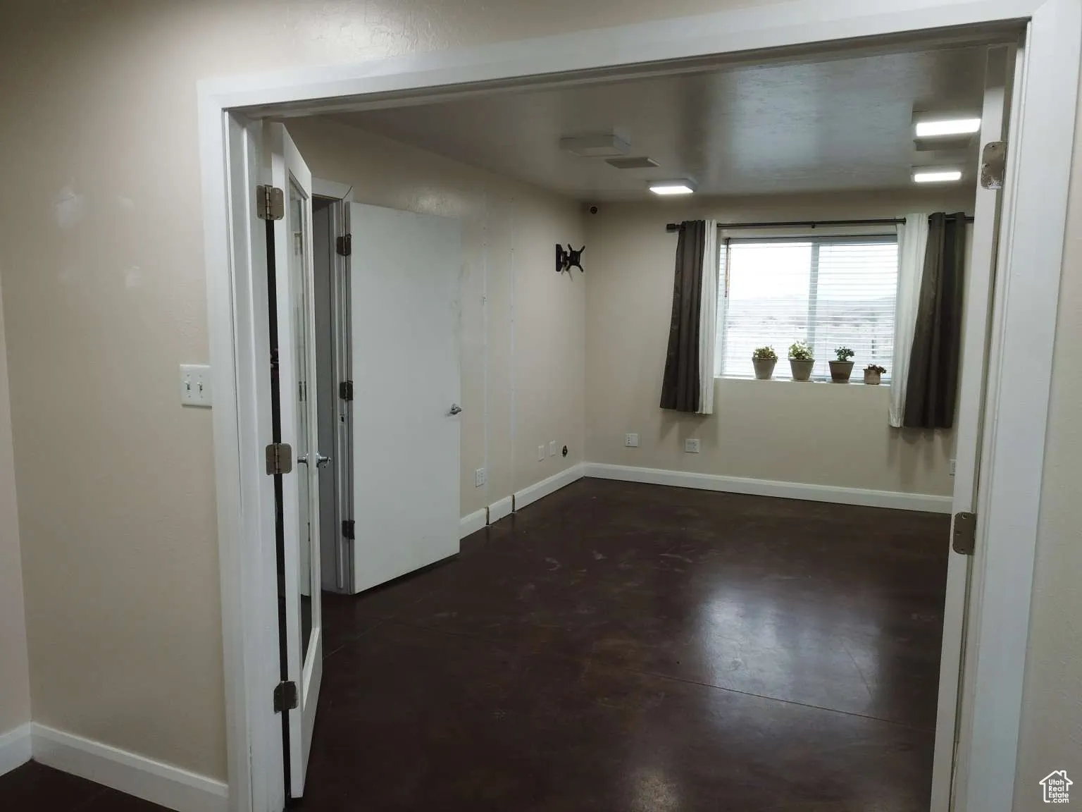 Spare room with concrete floors and baseboards