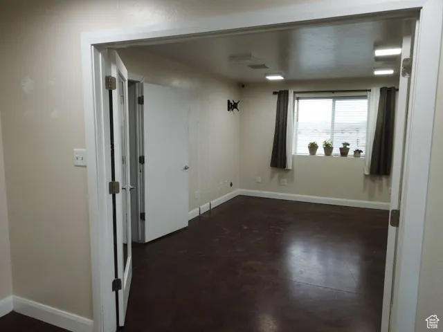 Spare room with concrete floors and baseboards