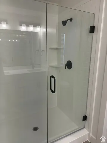 Bathroom with a stall shower and a sink