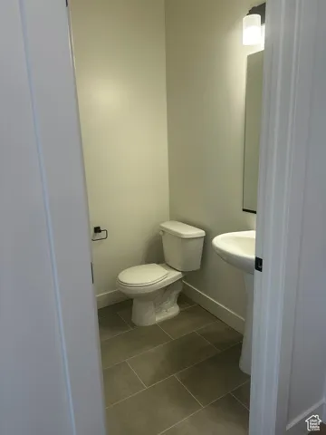 Bathroom featuring baseboards and tile patterned flooring