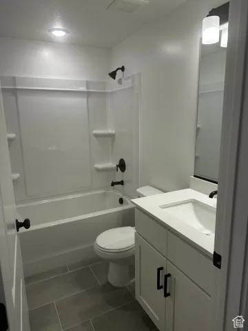 Full bathroom with vanity, bathtub / shower combination, and tile patterned floors