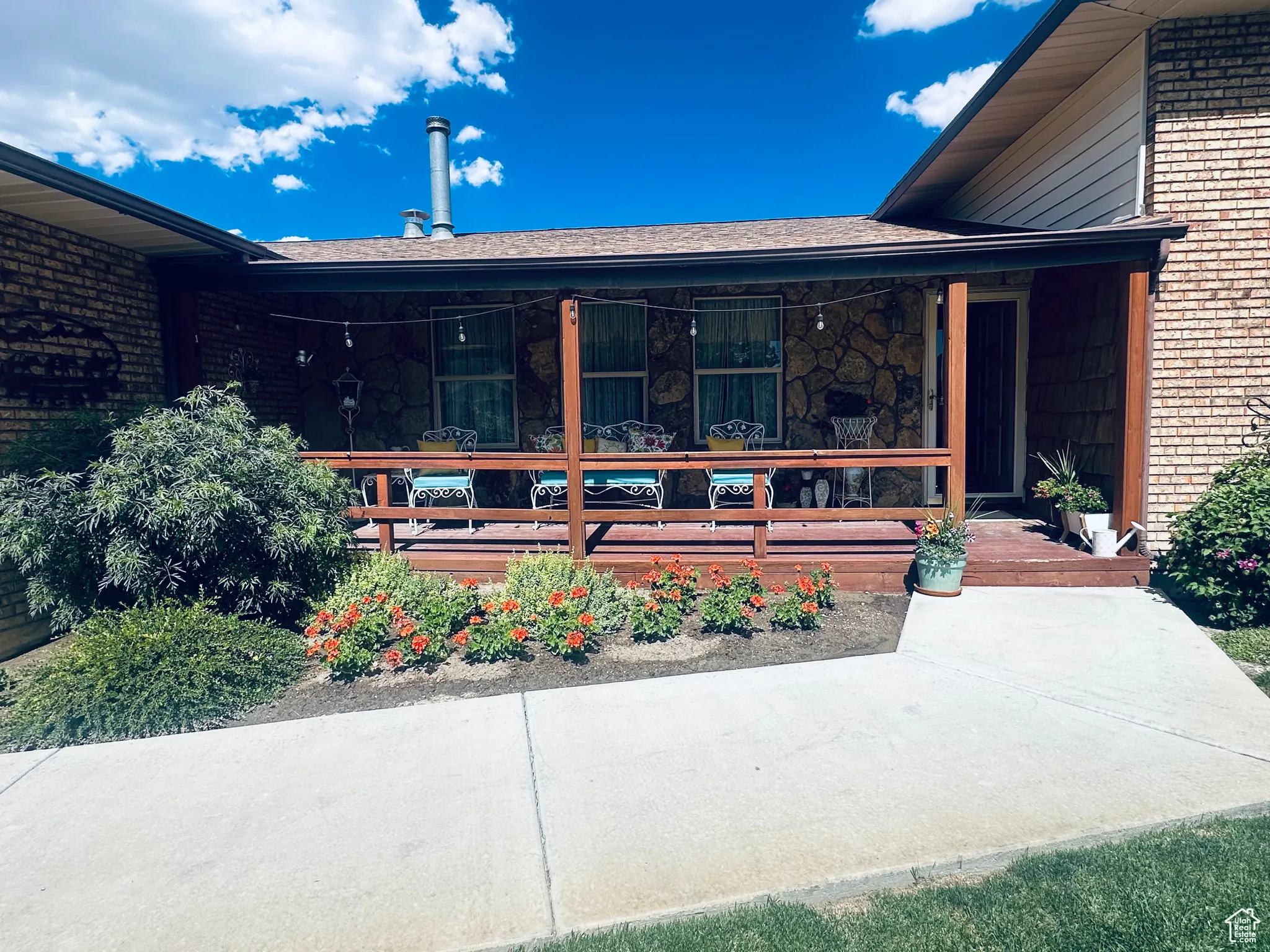 Doorway to property with covered porch and brick siding
