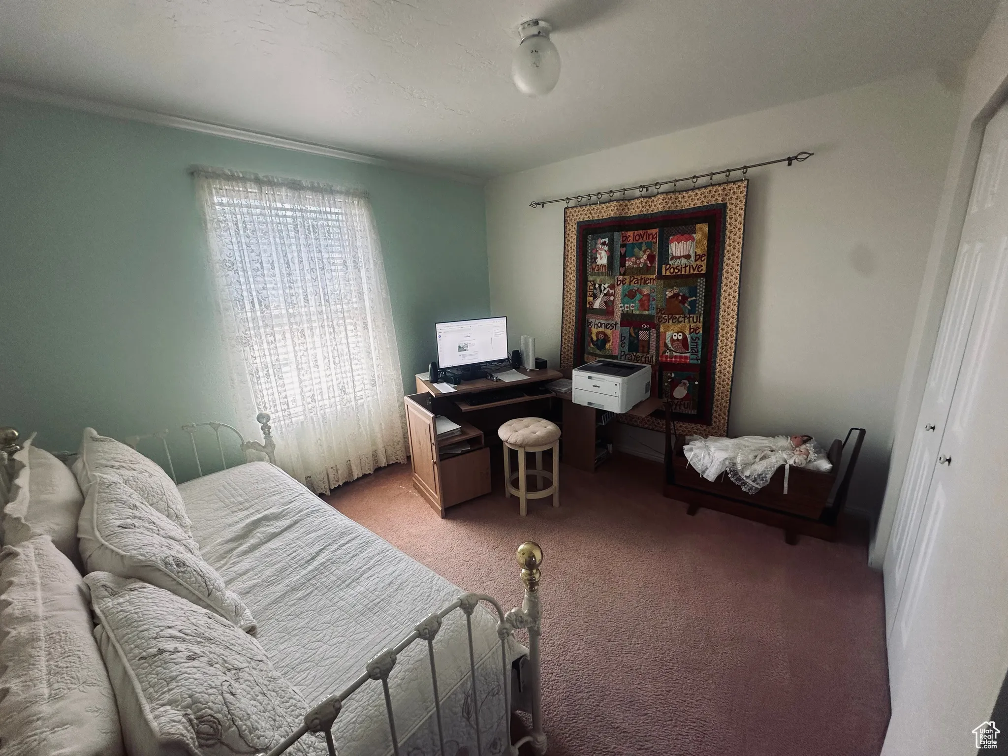 Bedroom with carpet floors and an office area