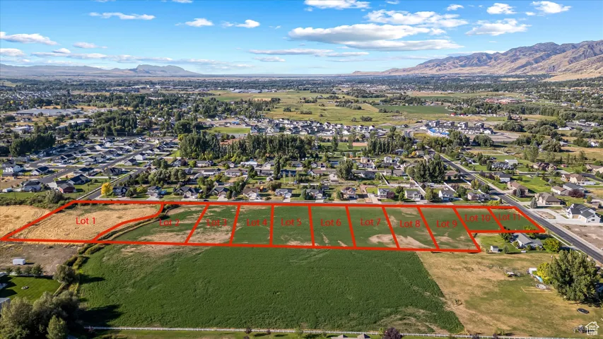 Aerial view of property and surrounding area featuring mountains and property boundaries highlighted