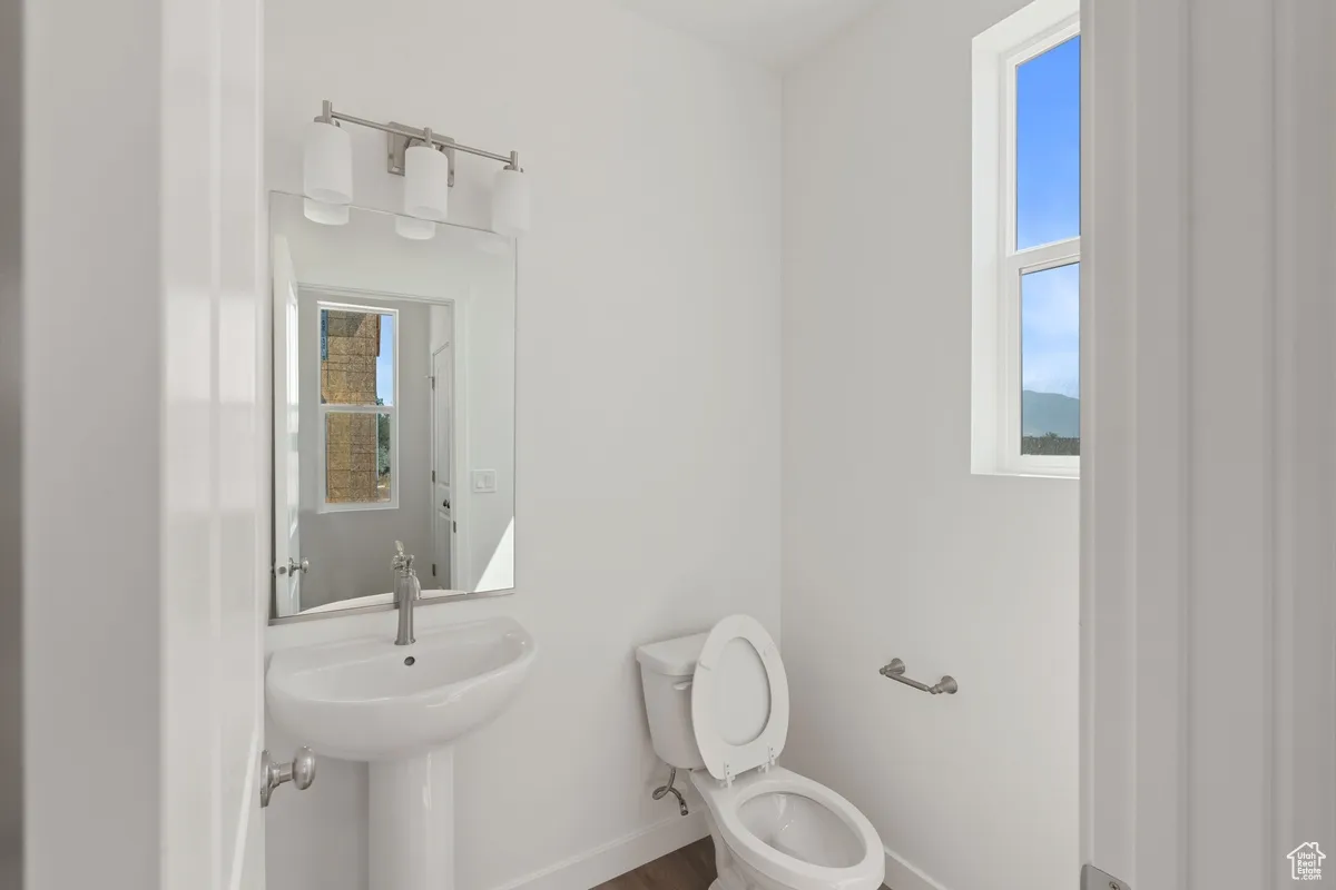 Bathroom featuring toilet and wood finished floors