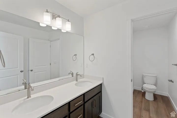 Bathroom featuring wood finished floors and double vanity