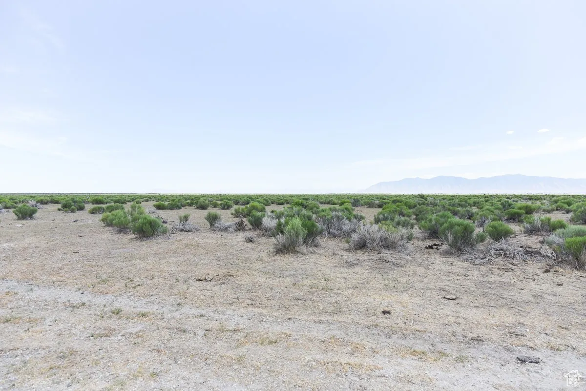 View of undeveloped land with a mountainous background and rural landscape